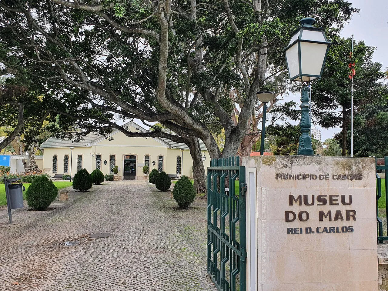 The entrance gate and tree-lined grounds of the Museu do Mar Rei D. Carlos in Cascais.