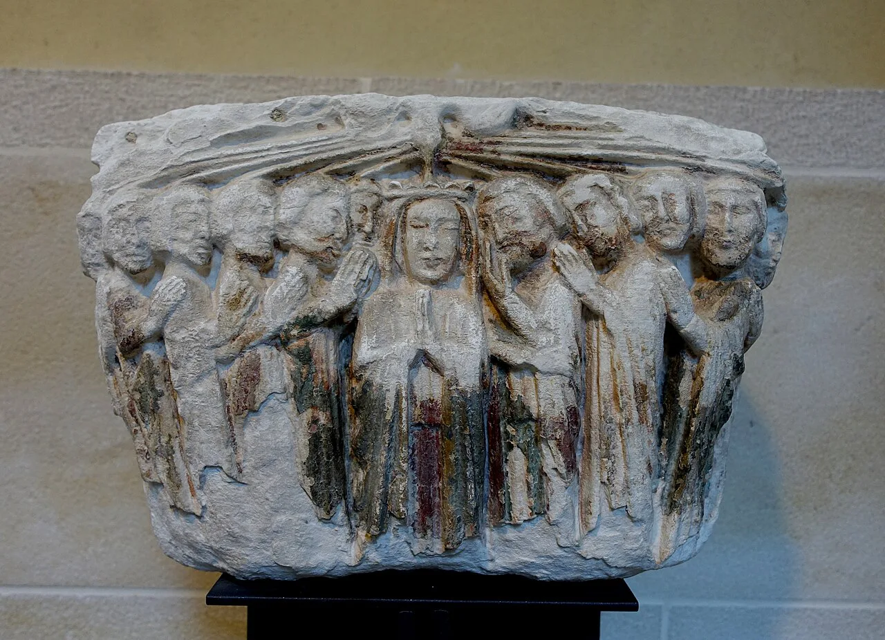 A carved stone Pentecost capital from the Mosteiro de Celas in the Museu Nacional Machado de Castro.