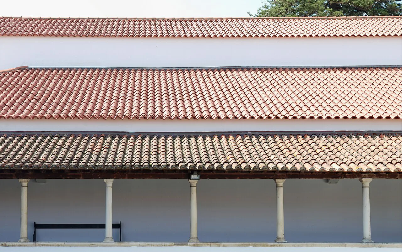 Tiled roofs above a colonnaded gallery at the Museum of Aveiro.