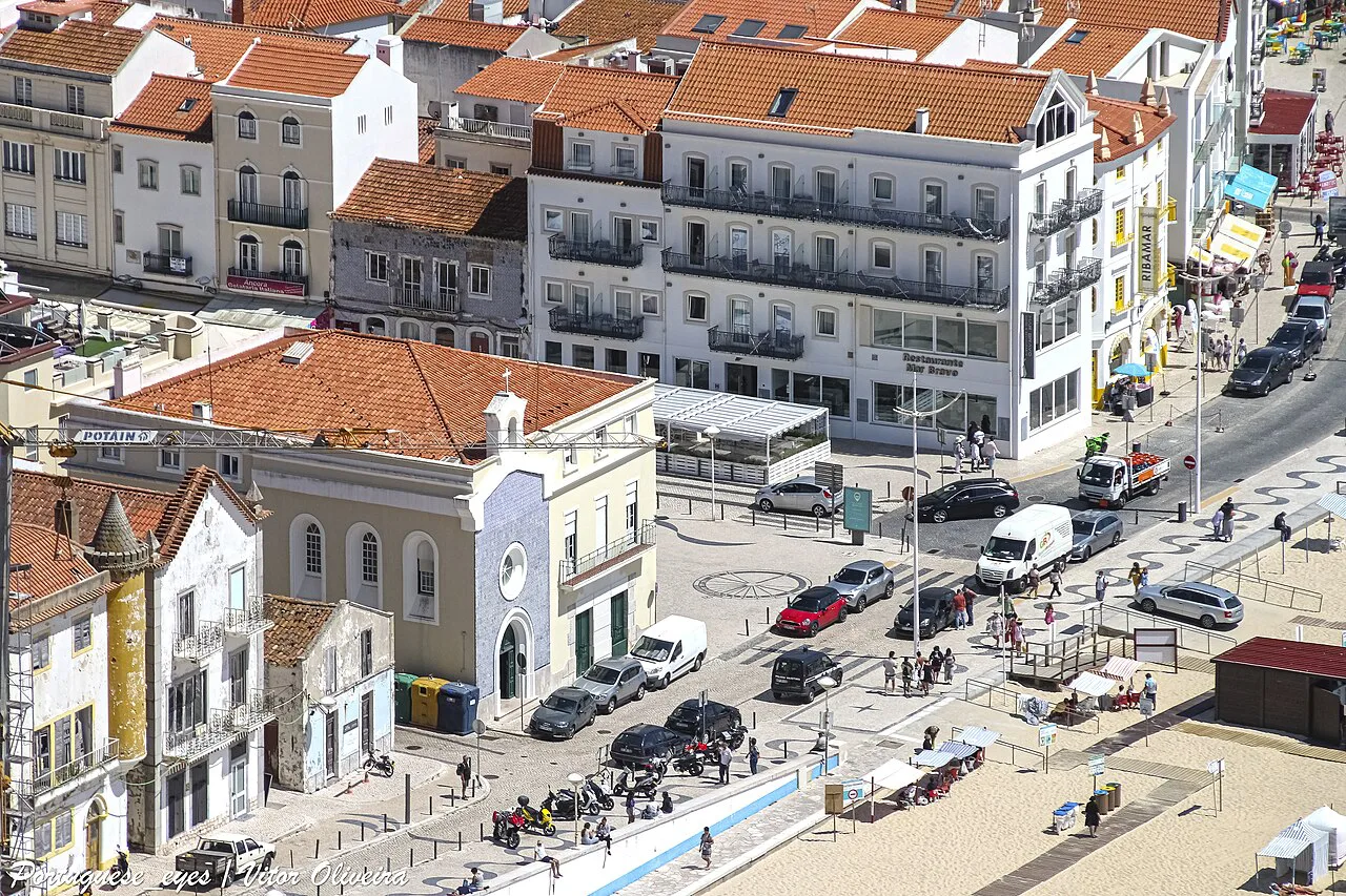 Rooftops and streets of Nazaré seen from above, near the beachfront.