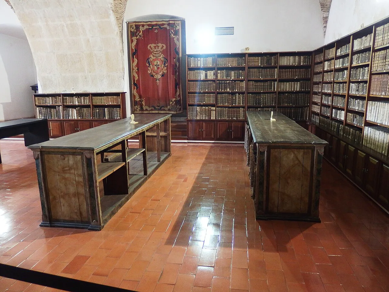Bookcases and reading tables on the middle floor of the Biblioteca Joanina at the University of Coimbra.