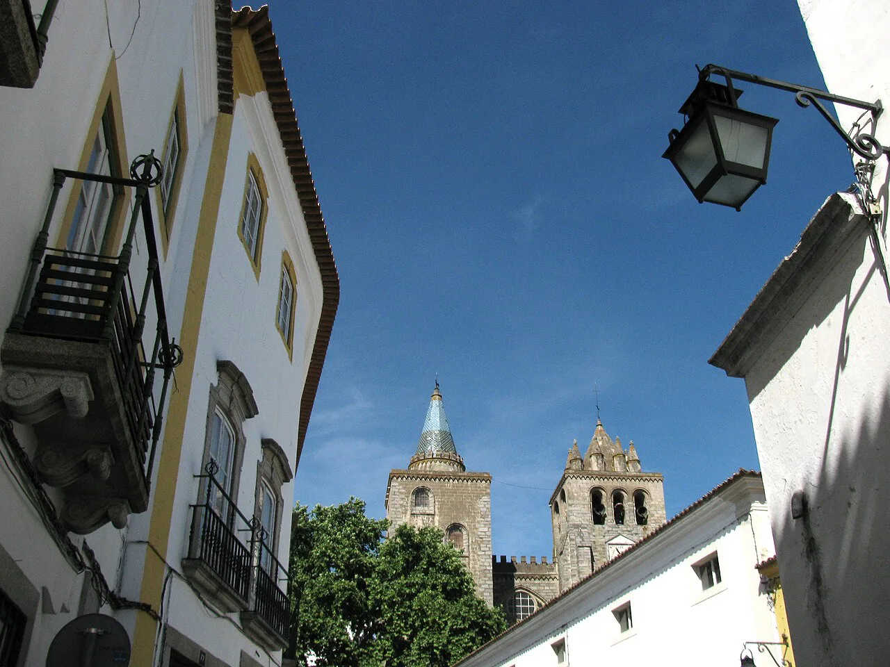 A street in the historic centre of Évora with the cathedral towers behind.