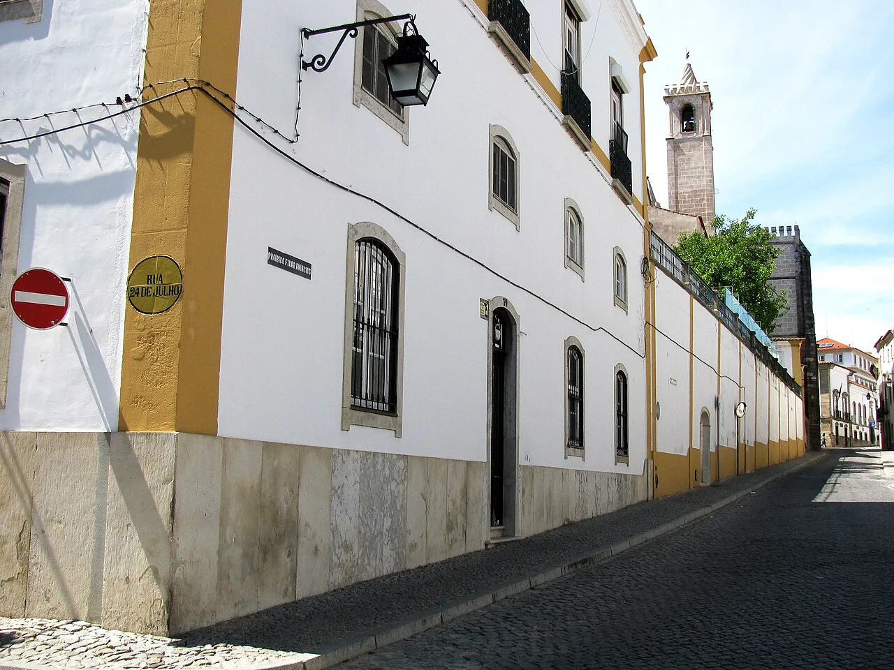 A whitewashed street with yellow trim in the historic centre of Évora.
