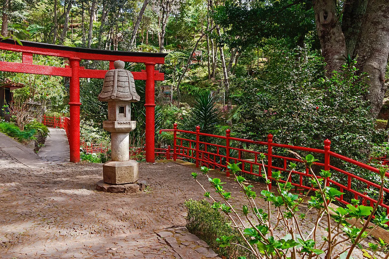 Red gateway and stone lantern in the Oriental Gardens of the Monte Palace Tropical Garden in Monte, Funchal.
