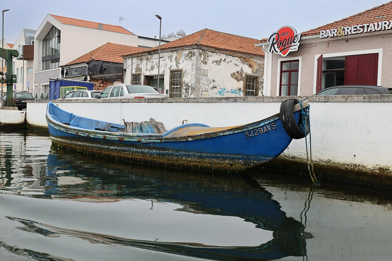 A painted boat moored on a canal in Aveiro.