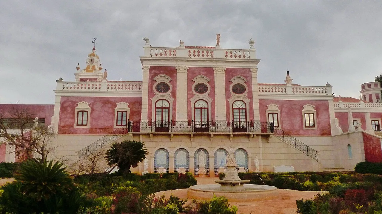 The pink façade and formal gardens of the Palácio de Estoi near Faro.