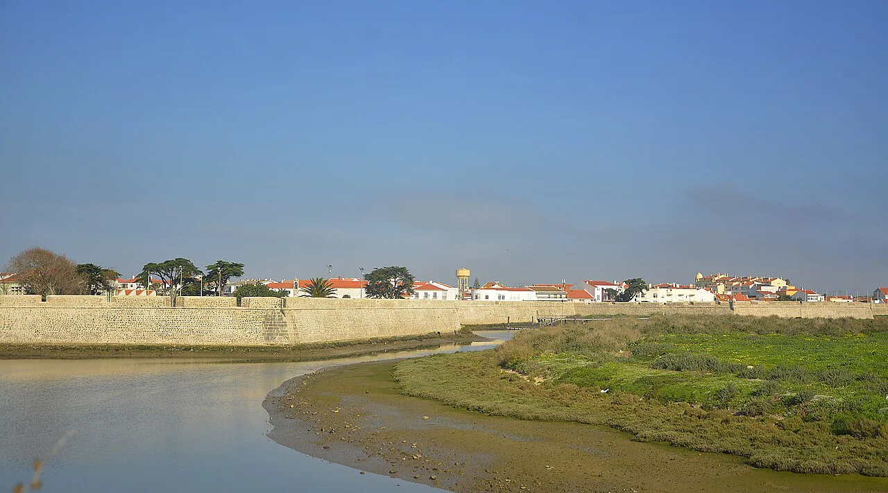 Old defensive walls along a river channel in Peniche.