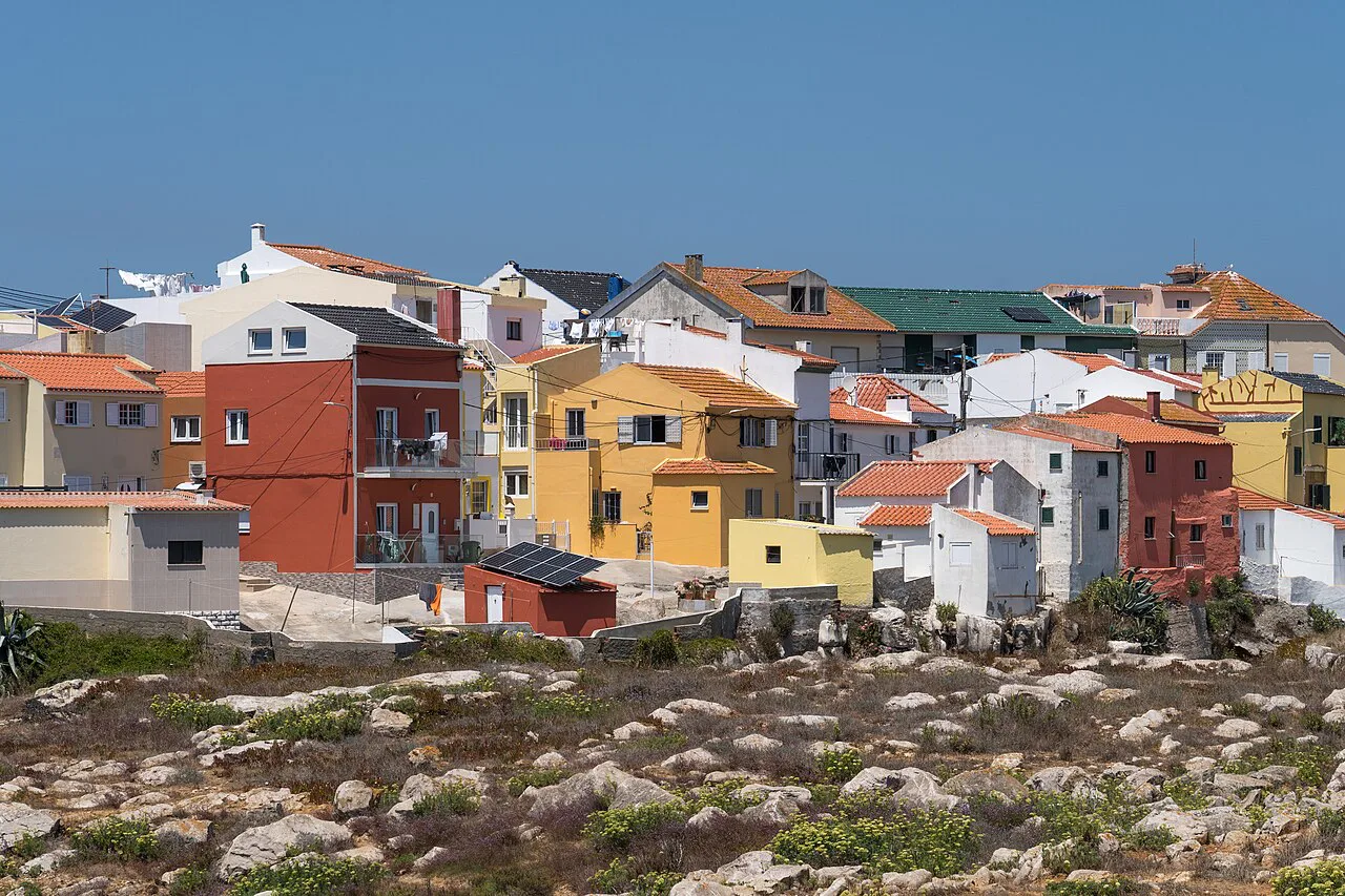 Colourful houses above the rocky shore in Peniche.