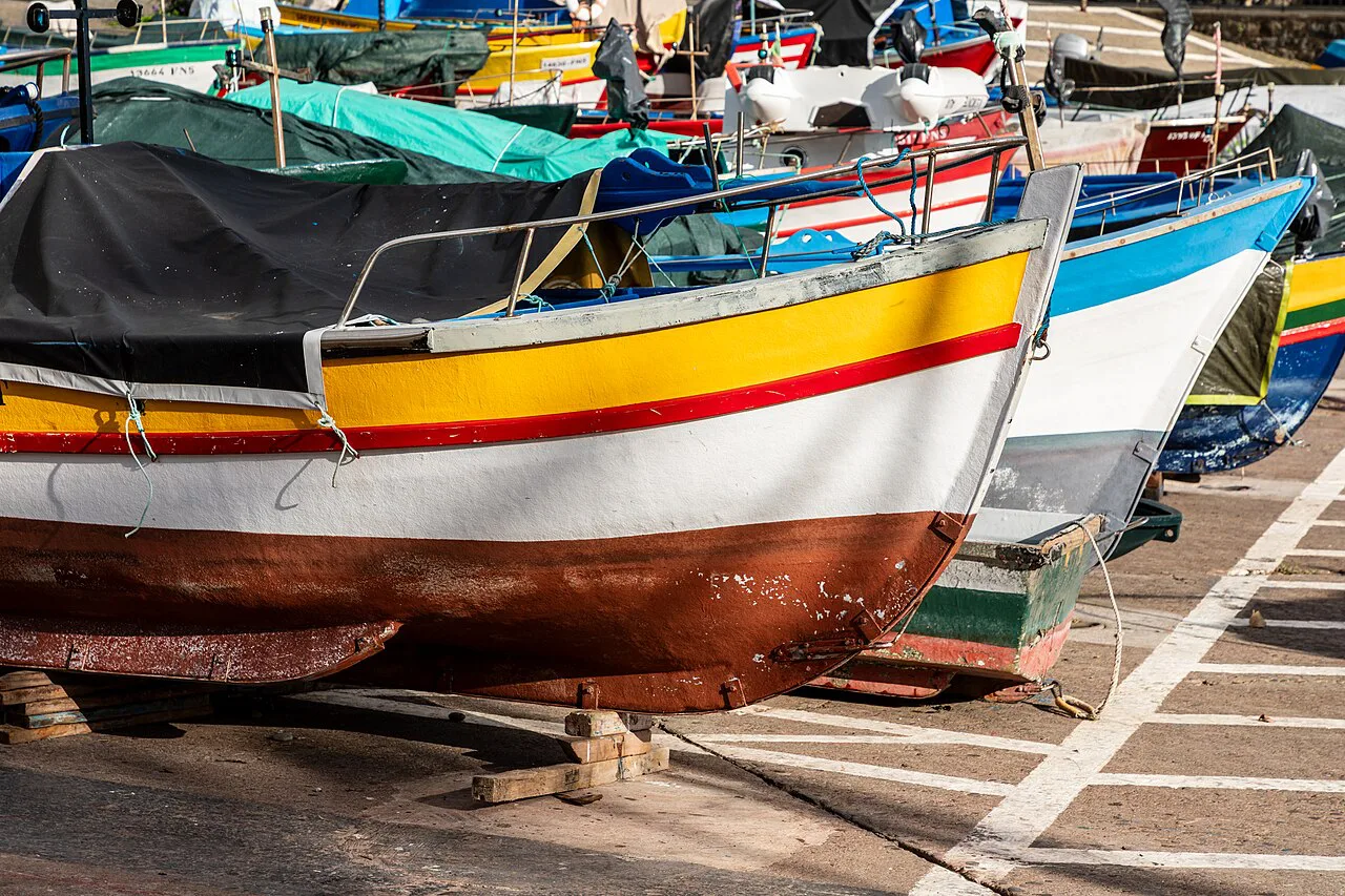 Painted fishing boats in the harbour at Câmara de Lobos, Madeira.