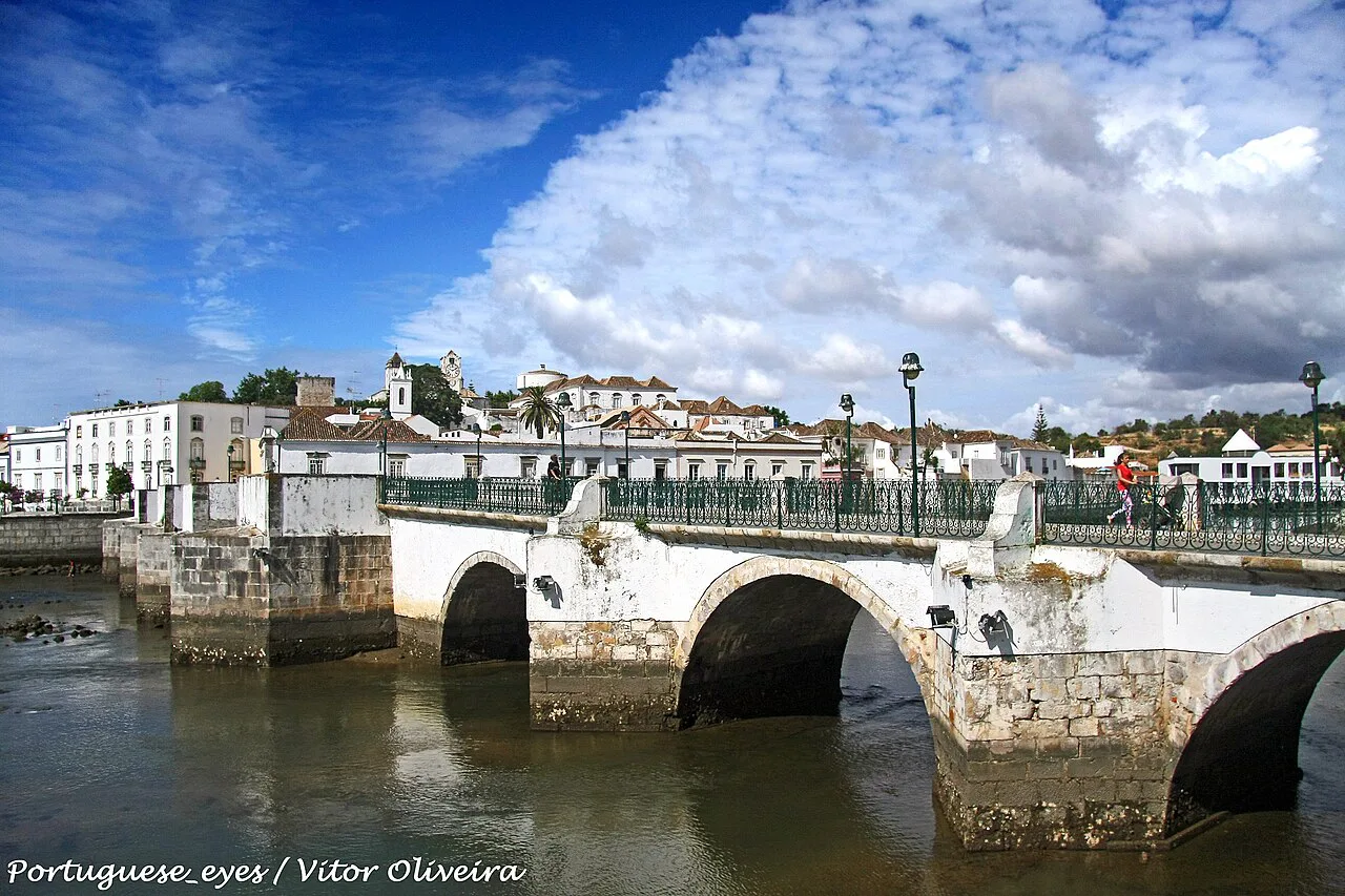 The arches of the Ponte Antiga over the River Gilão in Tavira.