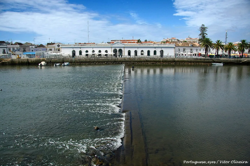 The weir on the Rio Gilão with Tavira's riverside buildings beyond.