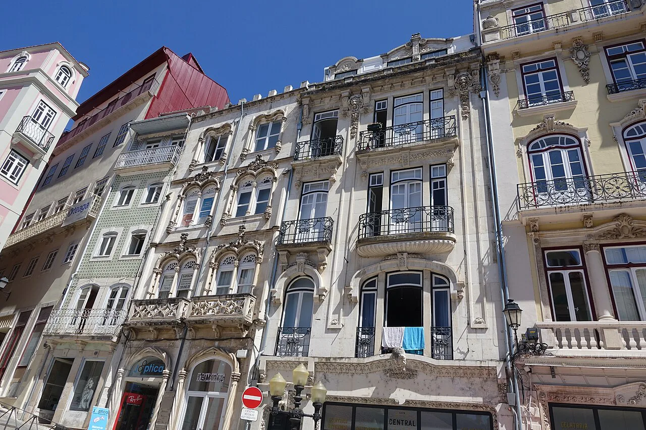 Ornate building façades on a street in Coimbra.