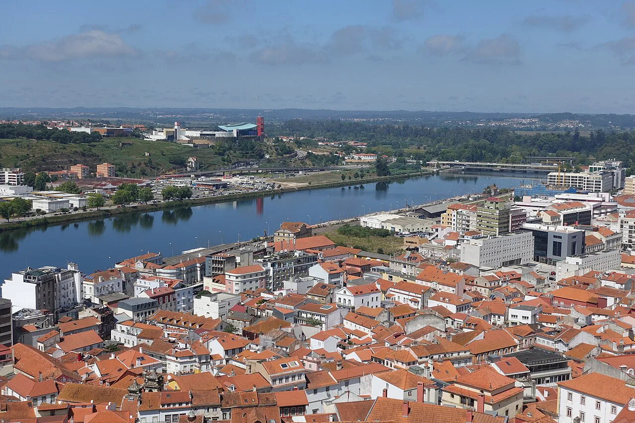 Red-roofed buildings of Coimbra above the river.