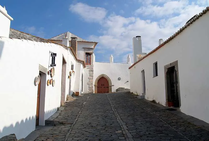 A cobbled street of whitewashed houses in Monsaraz in the Alentejo.