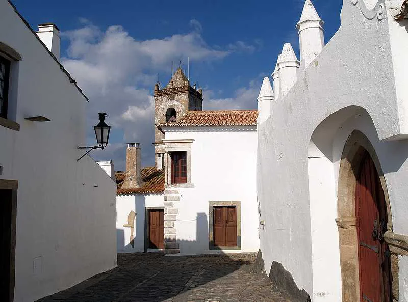 Whitewashed houses and a church tower in the village of Monsaraz in the Alentejo.