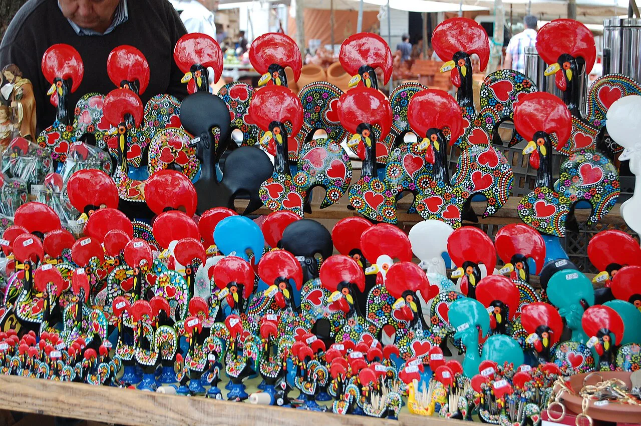 Painted Barcelos rooster figures displayed at the Barcelos market.