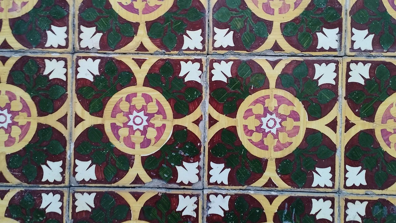 Patterned green, red and yellow tiles on a façade in Braga.