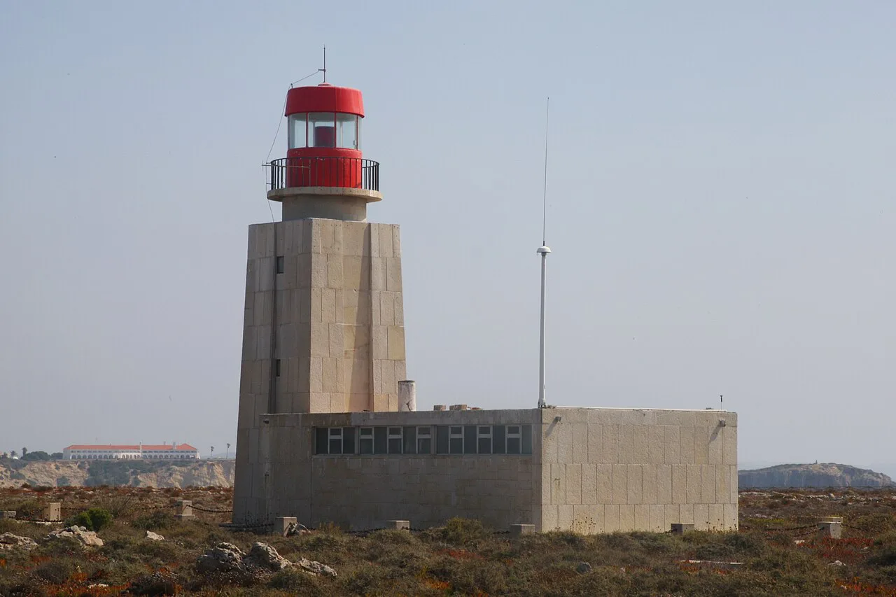 The Sagres Lighthouse with its red lantern on the headland.