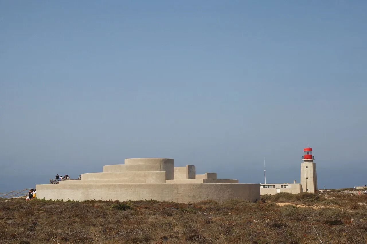 The Sagres Lighthouse on the headland beside a low modern structure.
