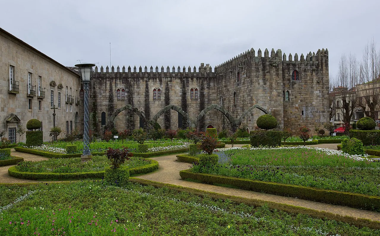Clipped box hedges of the Santa Bárbara Garden below medieval palace walls in Braga.