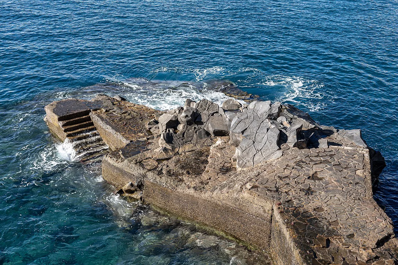 The rocky sea platform at the Miradouro do Lido pool area in São Martinho, Funchal.