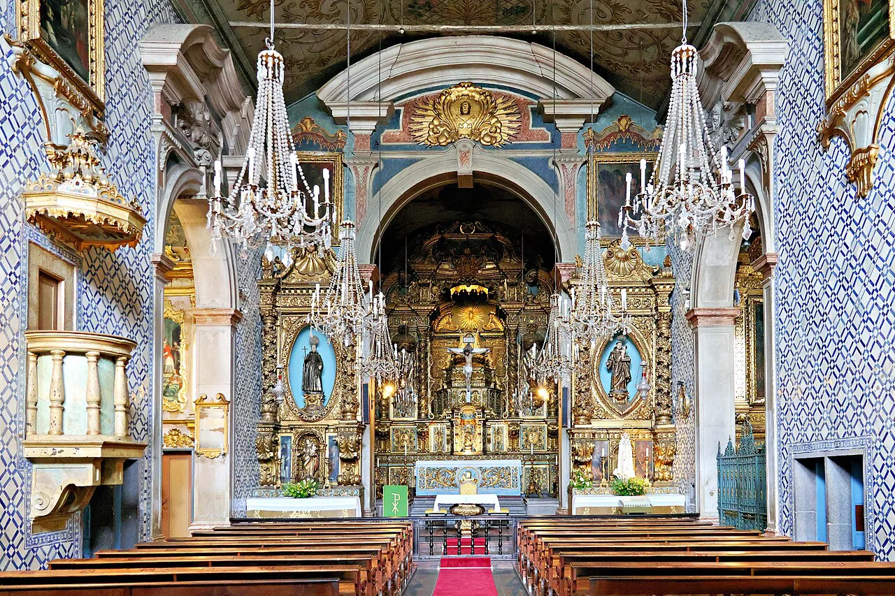 The gilded altar and azulejo-lined interior of the Igreja de São Pedro in Funchal.