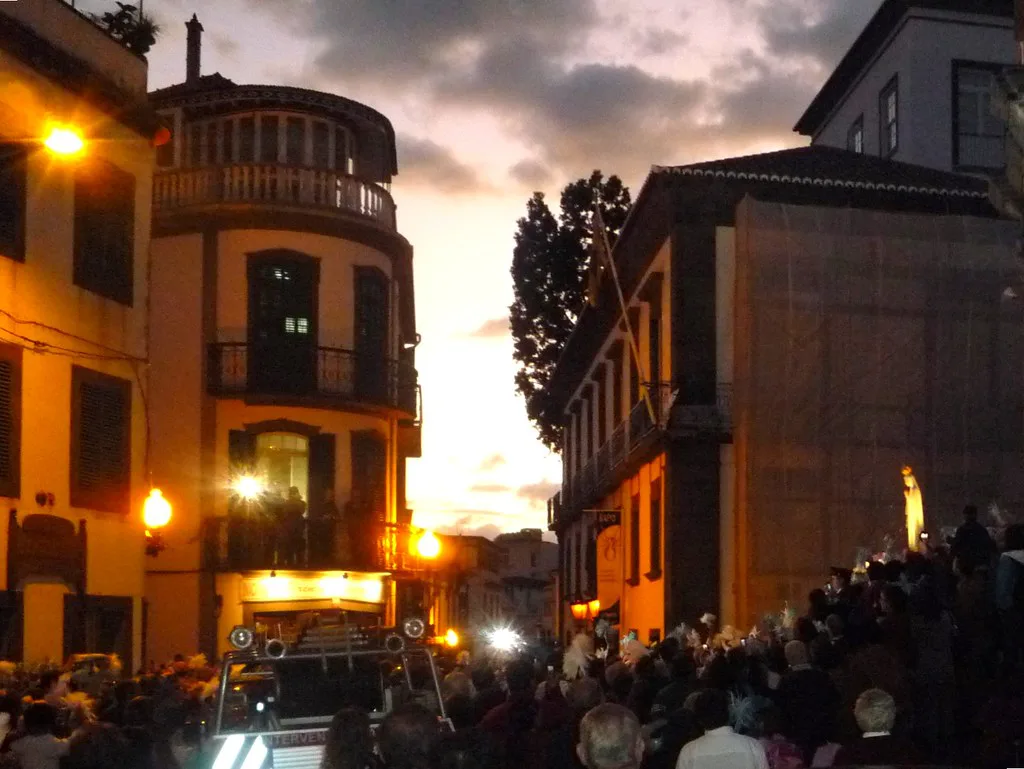 Crowds watch a night procession leaving the São Pedro church in Funchal.