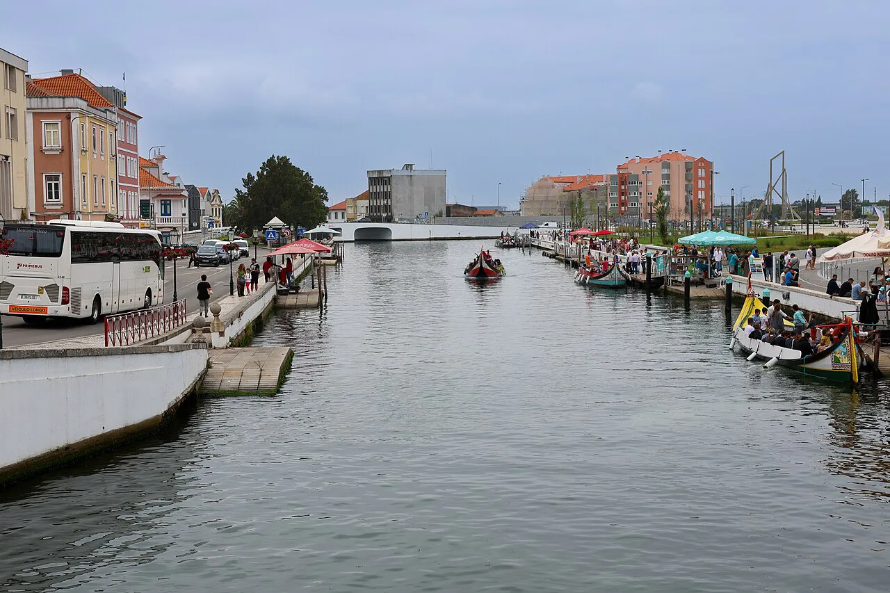 A canal in Aveiro lined with moored moliceiro boats.