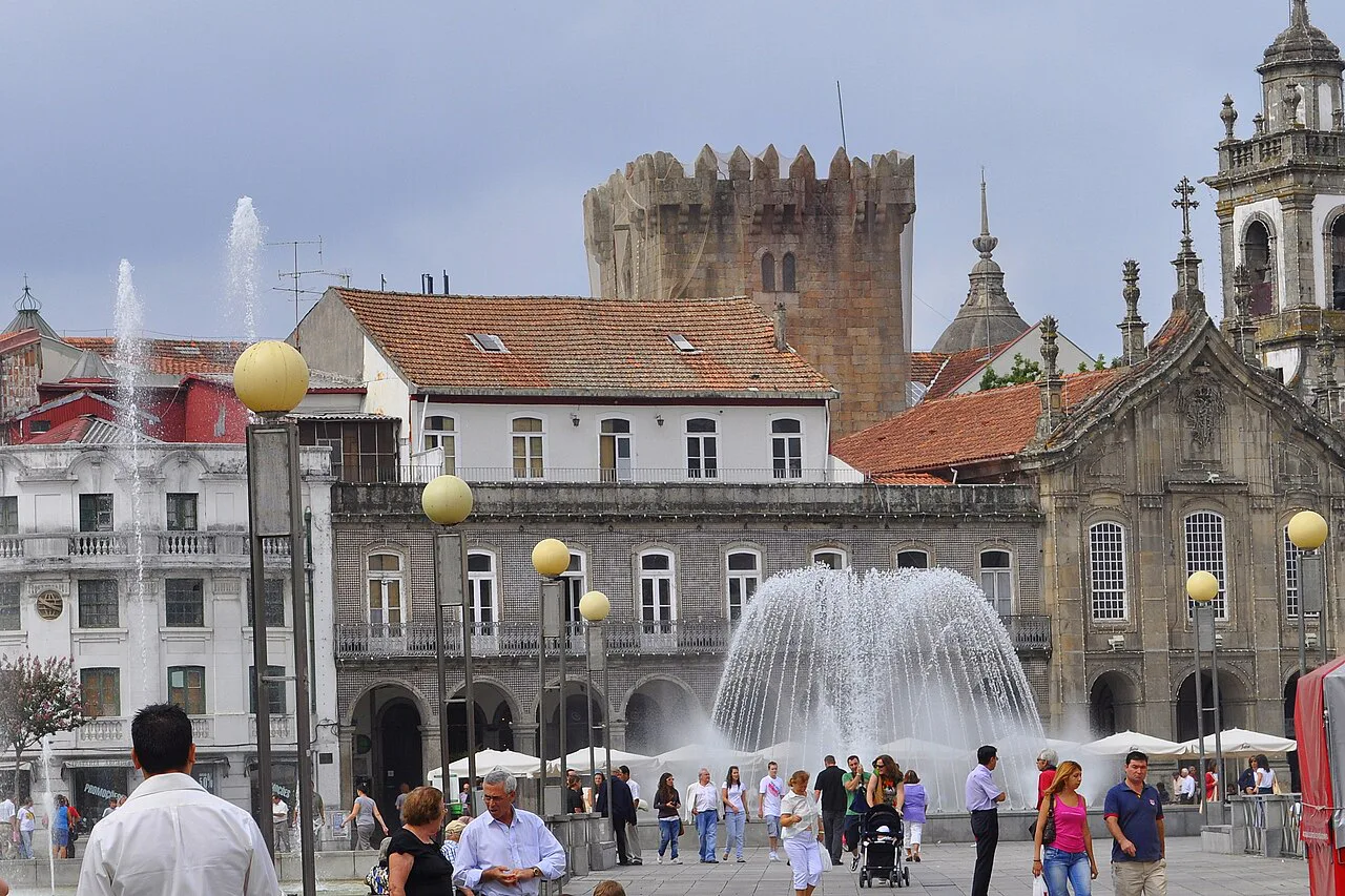 The fountain on Avenida Central in Braga, with the old keep behind.