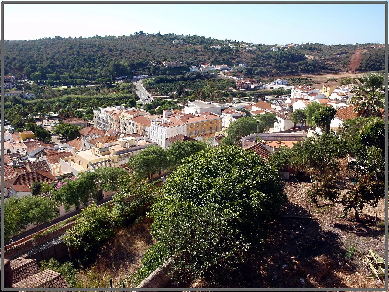 White houses and red roofs spread across the hillside in Silves.