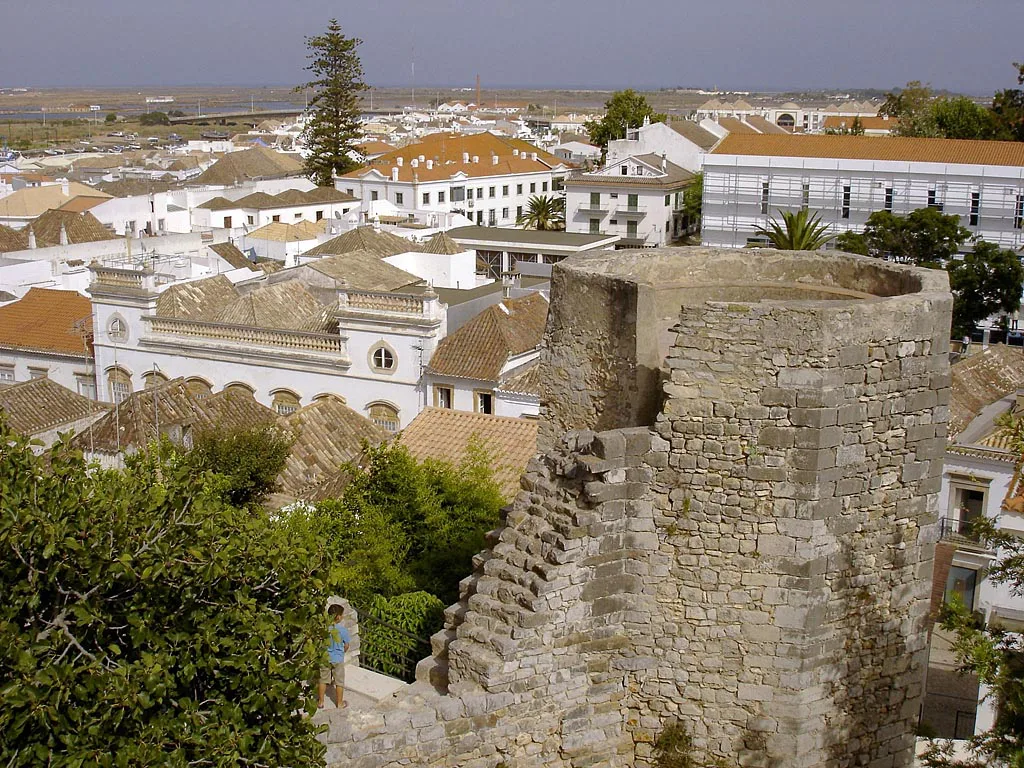 A tower of Tavira Castle above the town's rooftops.