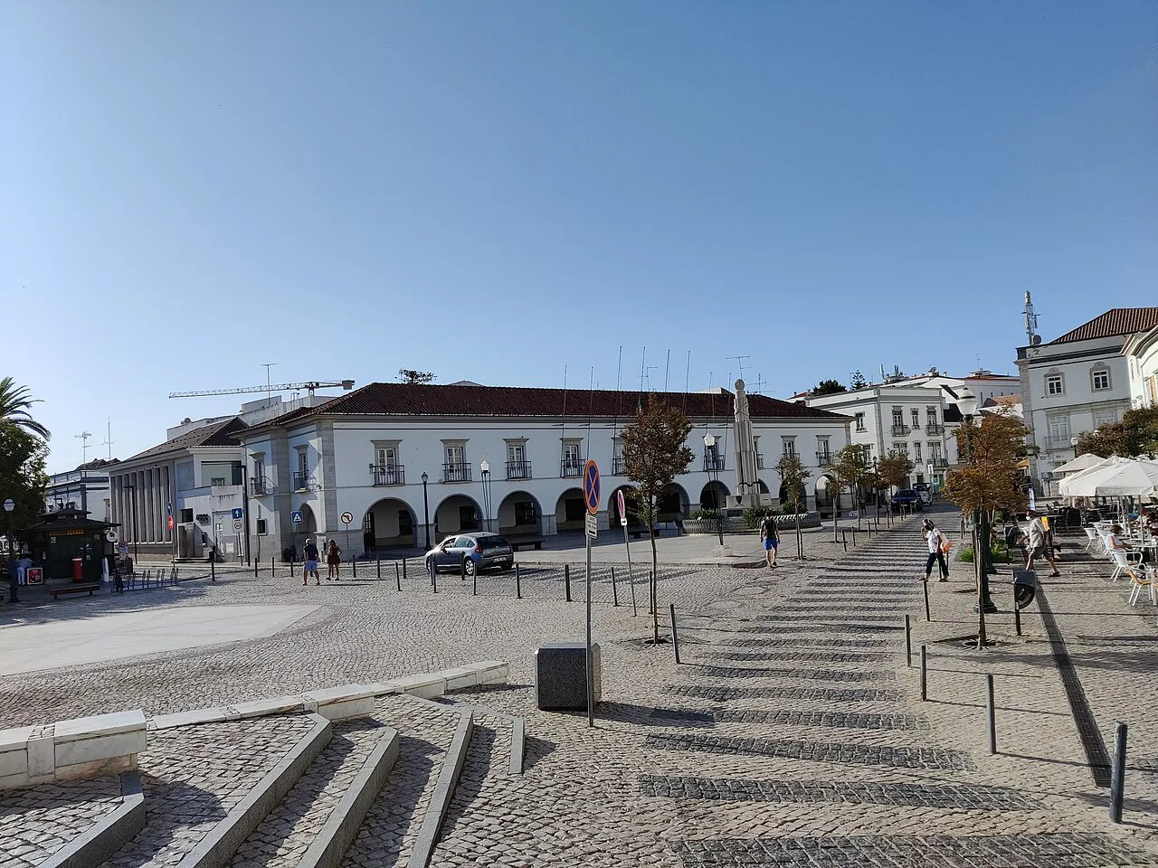 A paved square with white buildings in the centre of Tavira.