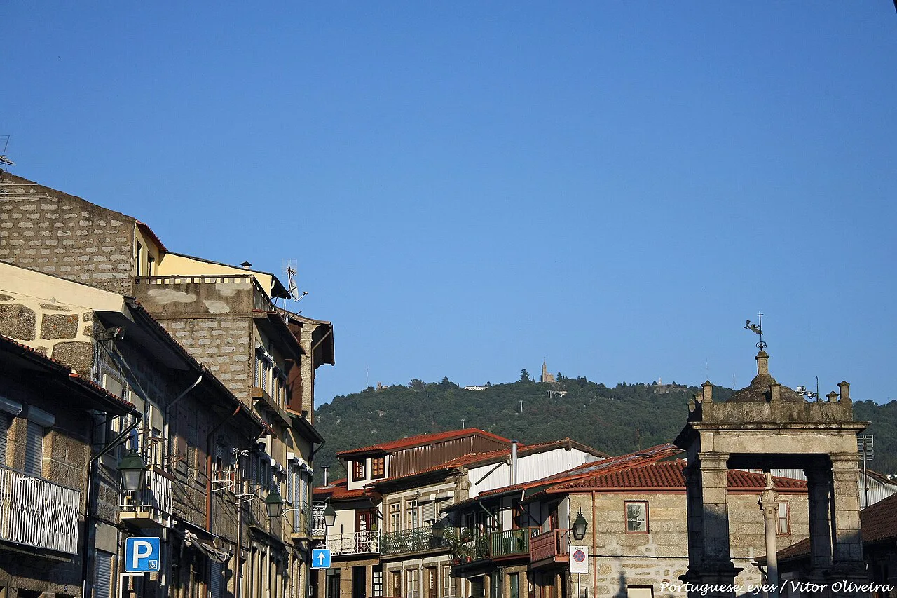 Old stone buildings along a street in Guimarães.
