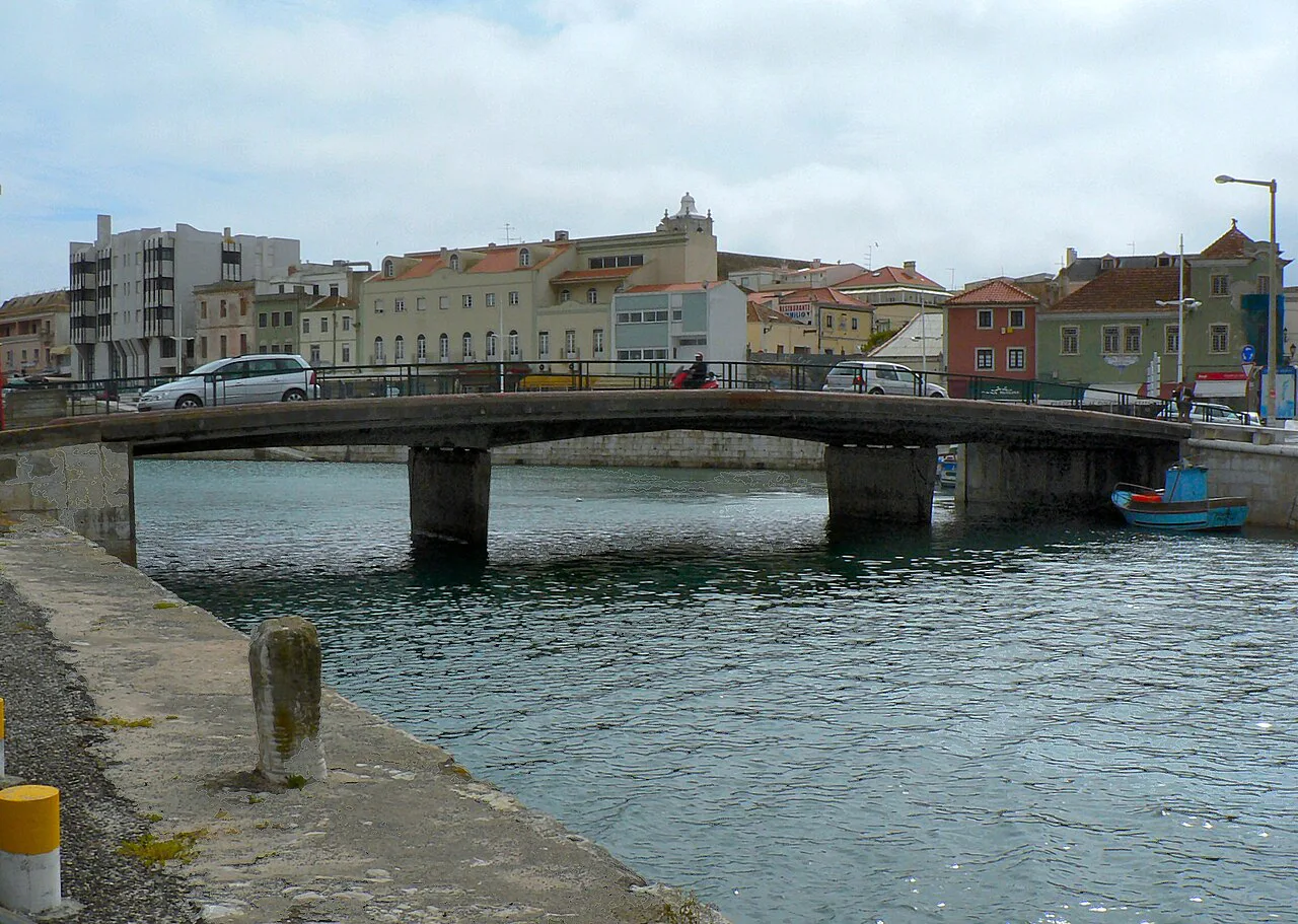 A bridge over the water in Peniche, with the town behind.