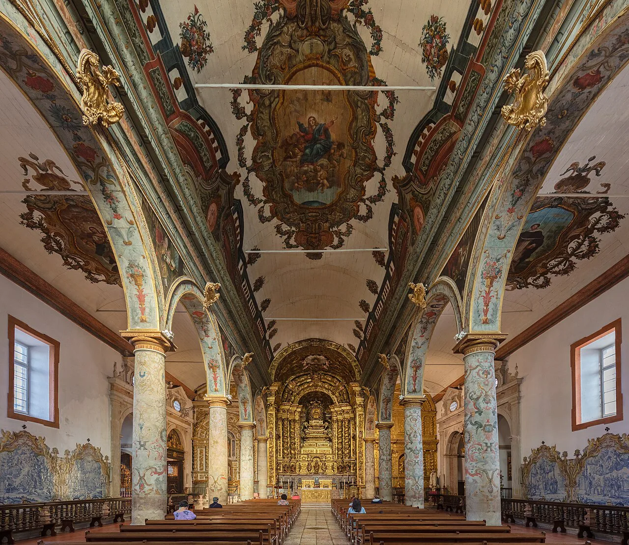 The painted ceiling and azulejo-lined nave of the Church of Santa Maria da Graça in Setúbal.