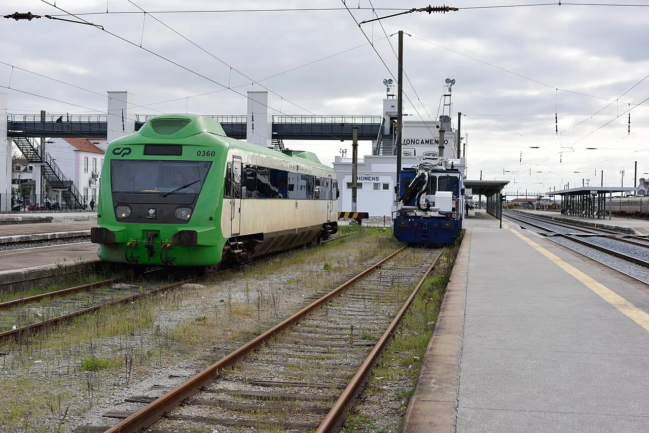 Comboios de Portugal trains at a station platform.