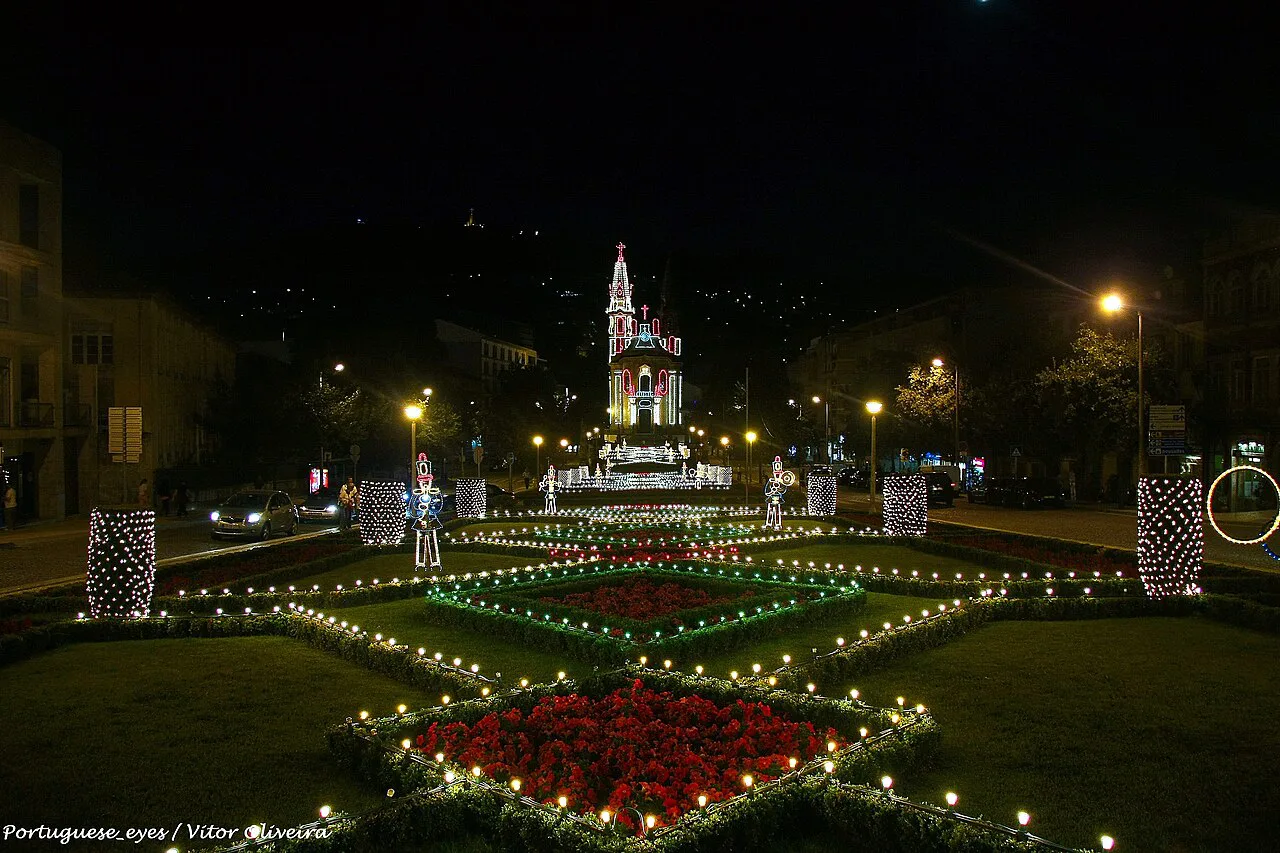 Illuminated gardens in Guimarães at night.