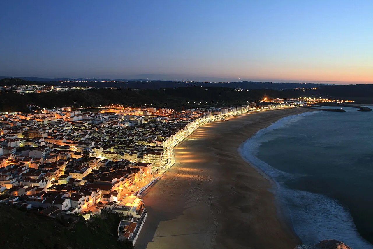 The historic centre and beach of Nazaré at dusk.