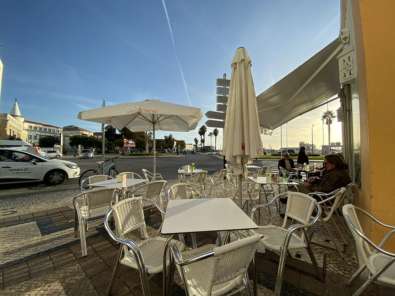 Outdoor café tables under umbrellas in Faro.