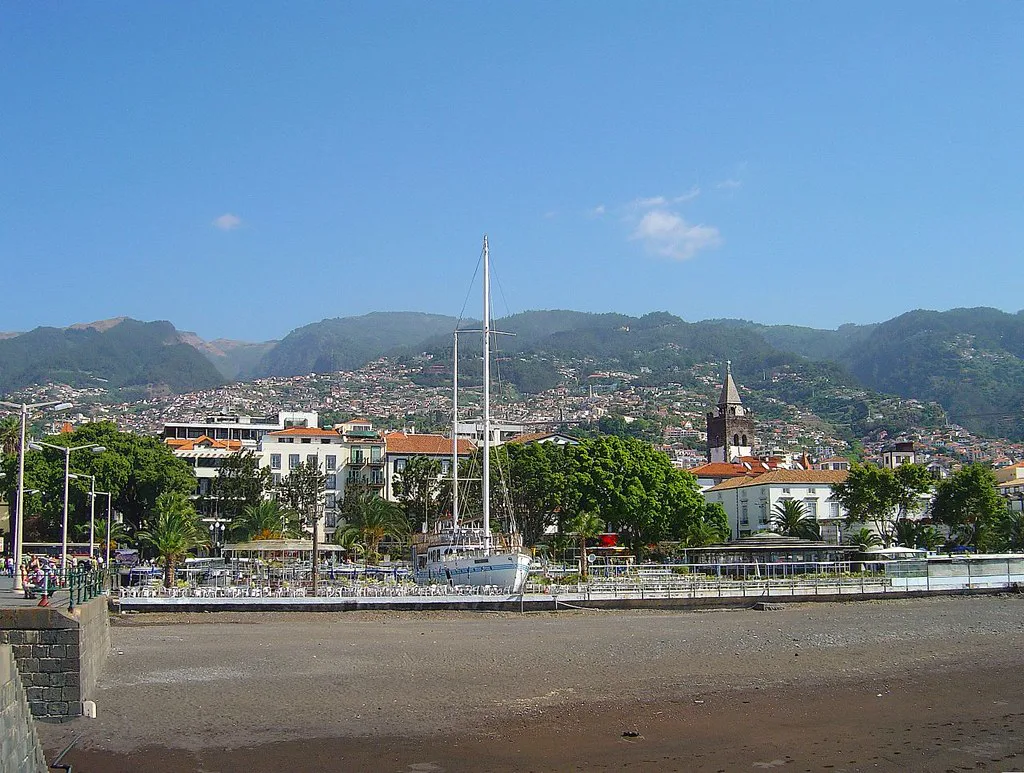 The waterfront of Funchal with houses rising towards the mountains.